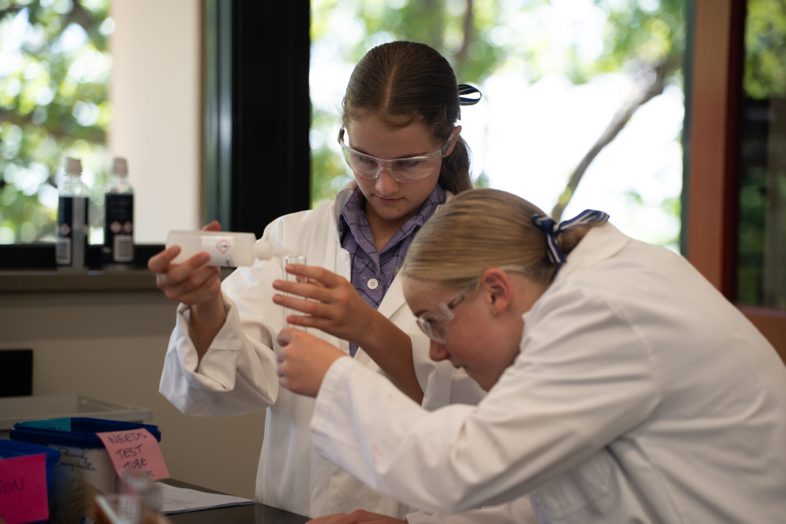 Two Frensham Students conducting an experiment in a science lab.